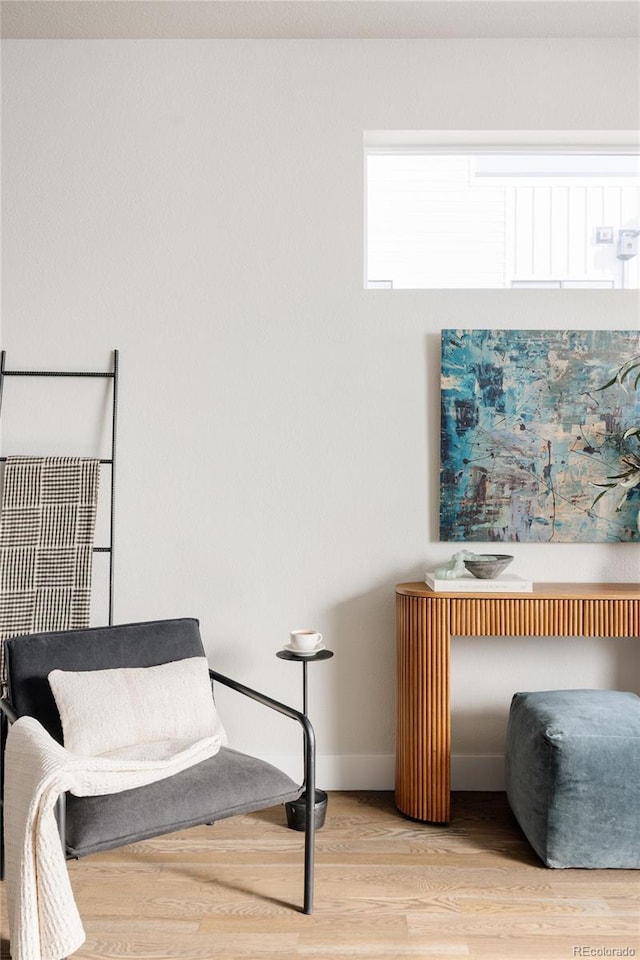 sitting room with wood finished floors and baseboards