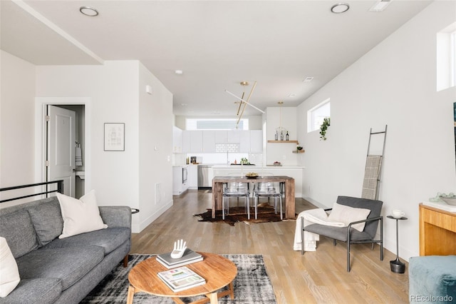 living room with light wood-style floors and baseboards