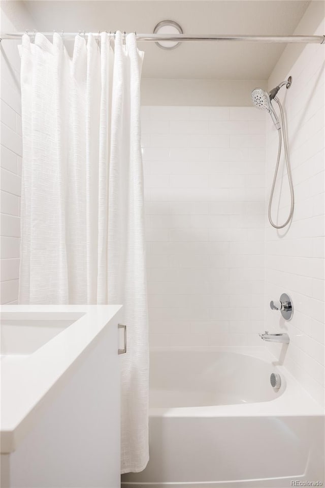 full bathroom featuring vanity and shower / bath combo with shower curtain