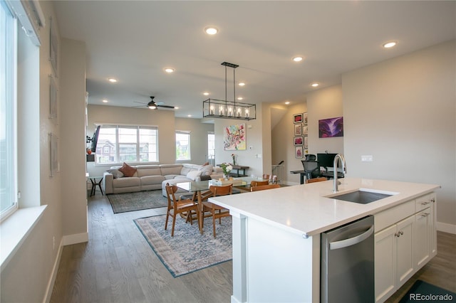 10018 E 62nd Ave, Denver, CO 80238 - kitchen with dishwasher, a sink, wood finished floors, a ceiling fan, and white cabinetry