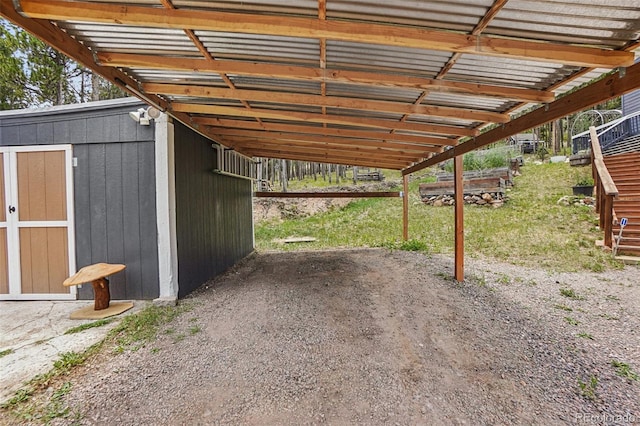 150 Cedar Rd, Evergreen, CO 80439 - view of parking featuring a carport and a storage unit