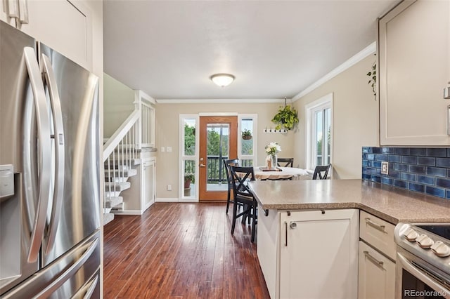 150 Cedar Rd, Evergreen, CO 80439 - kitchen with stainless steel appliances, dark wood finished floors, ornamental molding, a peninsula, and tasteful backsplash