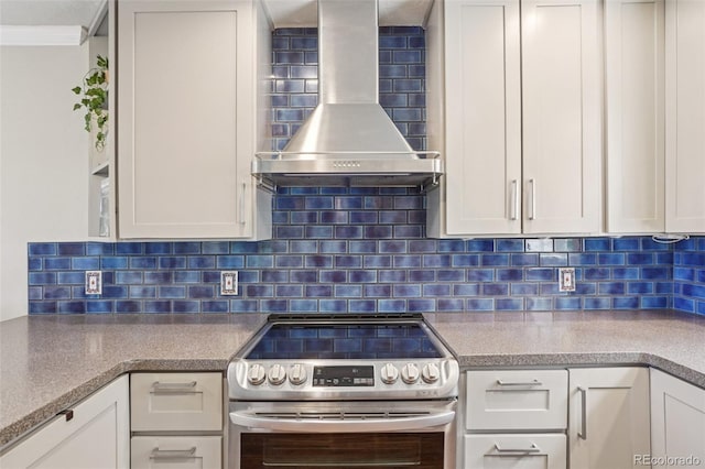 150 Cedar Rd, Evergreen, CO 80439 - kitchen featuring electric stove, wall chimney range hood, decorative backsplash, white cabinetry, and crown molding