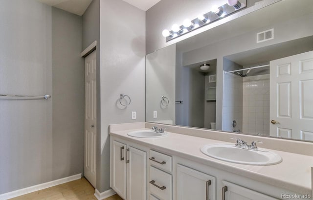 7440 S Blackhawk St Unit 12-204, Englewood, CO 80112 - full bathroom with double vanity, a shower, toilet, and baseboards