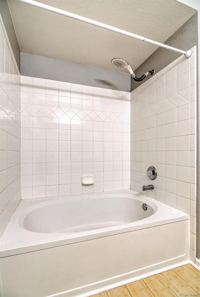 7440 S Blackhawk St Unit 12-204, Englewood, CO 80112 - bathroom with wood finished floors and bathing tub / shower combination