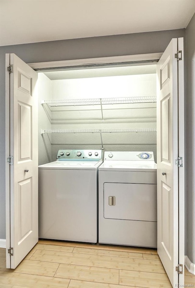 7440 S Blackhawk St Unit 12-204, Englewood, CO 80112 - washroom with washer and dryer and light wood-type flooring