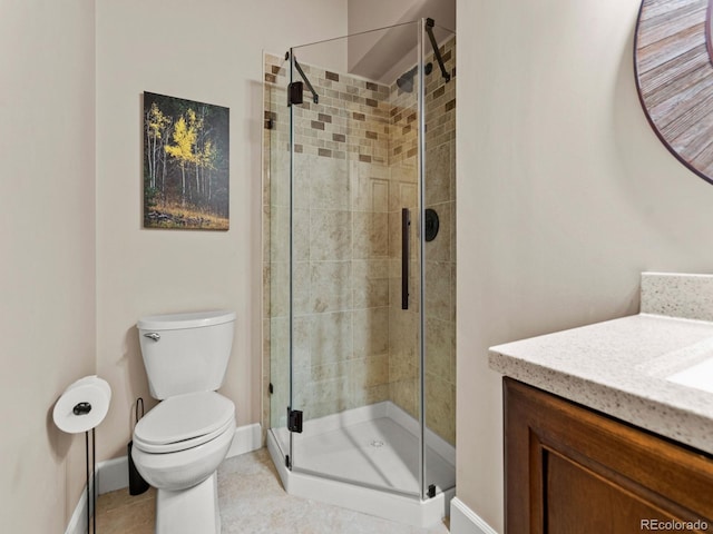 bathroom with tile patterned floors, vanity, toilet, and walk in shower