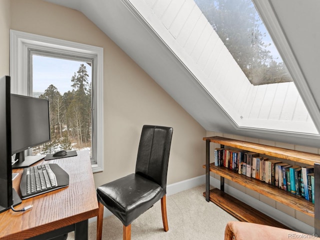 carpeted home office featuring plenty of natural light and lofted ceiling