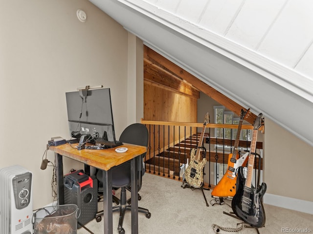 carpeted home office with vaulted ceiling