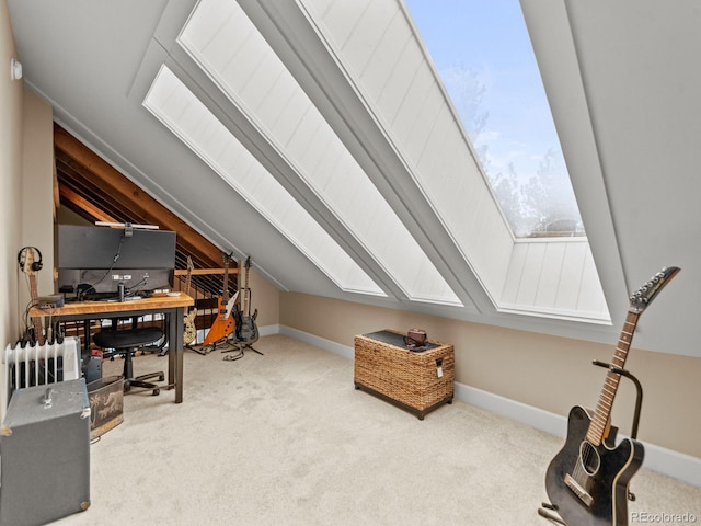 home office featuring light colored carpet and vaulted ceiling with skylight