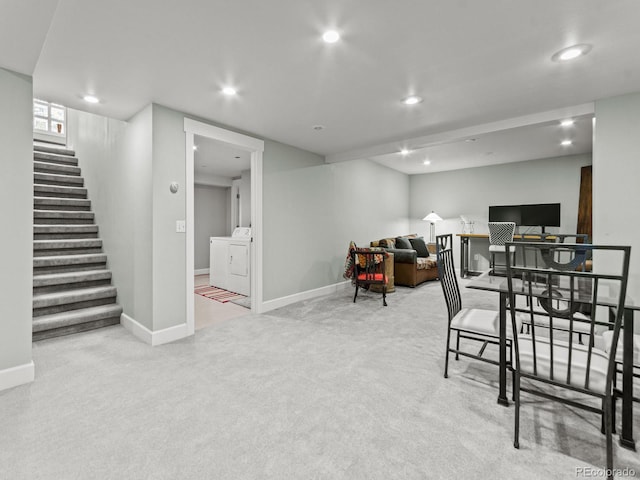 interior space with washer and clothes dryer and light carpet