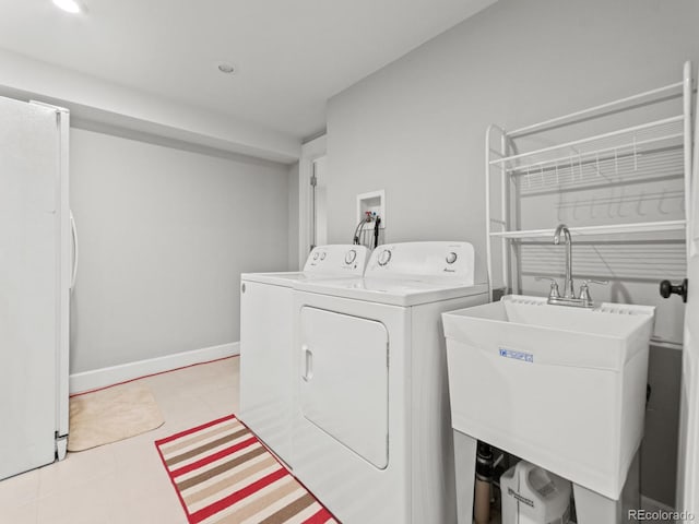 clothes washing area with sink and washing machine and clothes dryer