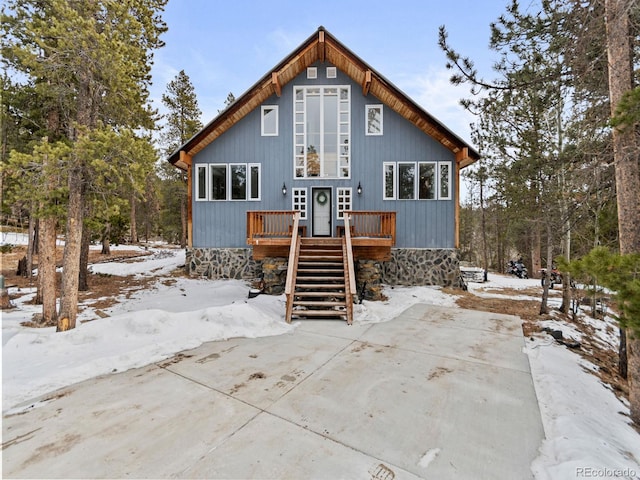 view of snow covered back of property