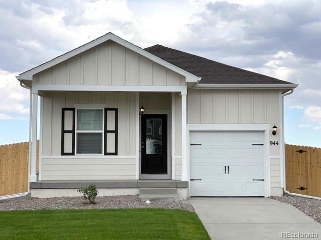 ranch-style house featuring a front yard and a garage