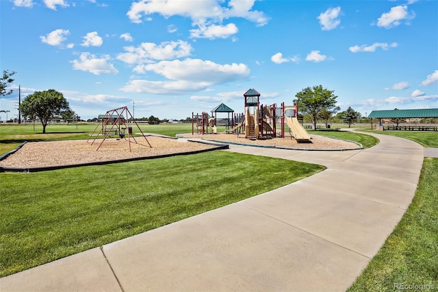 view of playground with a lawn