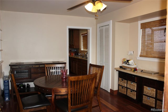 dining space with a ceiling fan and dark wood-type flooring