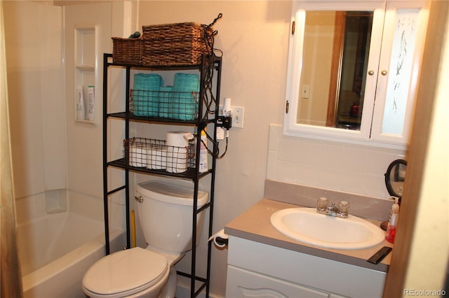 full bathroom featuring decorative backsplash, toilet, and vanity