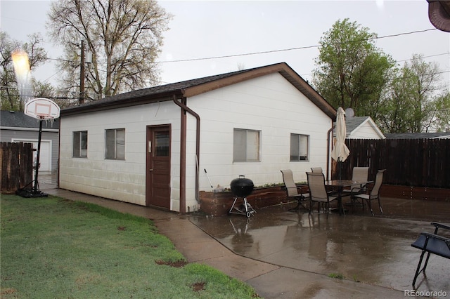 rear view of property with a patio area and outdoor dining area