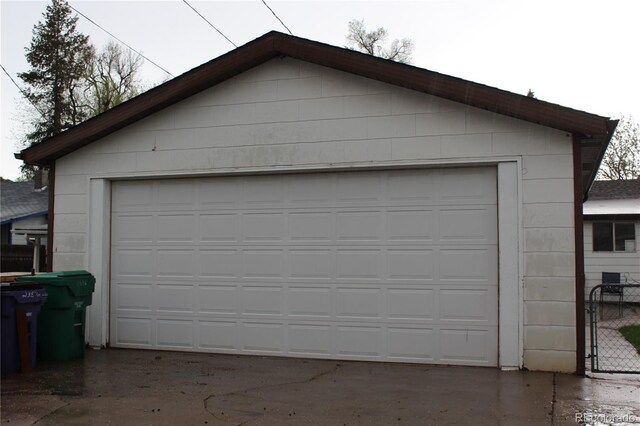 detached garage featuring fence