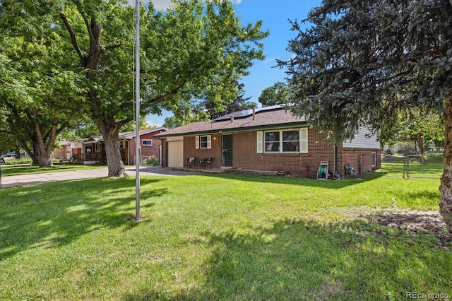 5193 Zinnia St, Arvada, CO 80002 - ranch-style house featuring a garage, solar panels, brick siding, and driveway