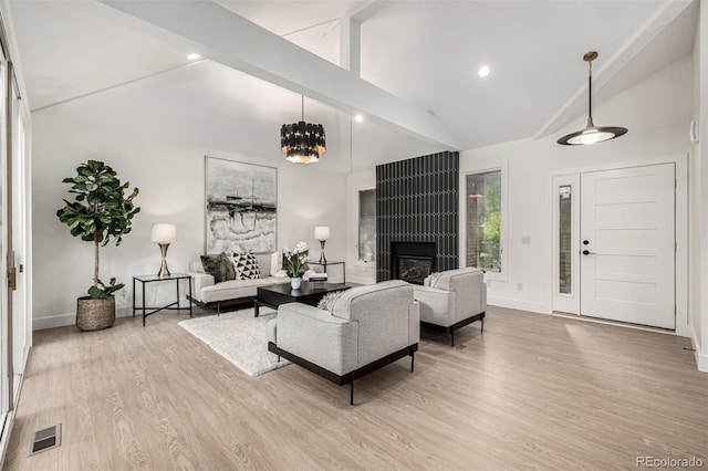 5401 E Dakota Ave Unit 22, Denver, CO 80246 - living area featuring beamed ceiling, wood finished floors, a fireplace, high vaulted ceiling, and a chandelier