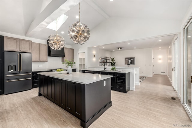 5401 E Dakota Ave Unit 22, Denver, CO 80246 - kitchen with high end fridge, a large island, light countertops, high vaulted ceiling, and light wood-style floors