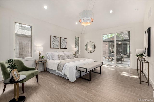 5401 E Dakota Ave Unit 22, Denver, CO 80246 - bedroom featuring access to outside, wood finished floors, vaulted ceiling, recessed lighting, and a chandelier