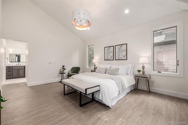 5401 E Dakota Ave Unit 22, Denver, CO 80246 - bedroom featuring a chandelier, high vaulted ceiling, wood finished floors, and connected bathroom