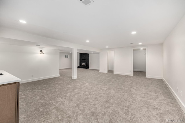 5401 E Dakota Ave Unit 22, Denver, CO 80246 - finished below grade area featuring recessed lighting, light carpet, and a brick fireplace
