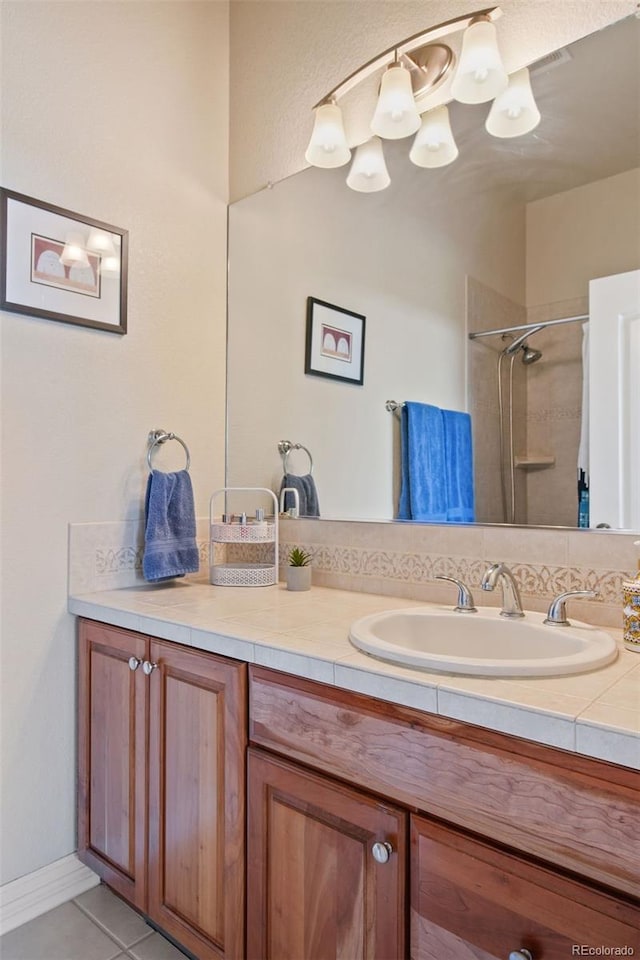 bathroom with vanity, walk in shower, and tile patterned flooring