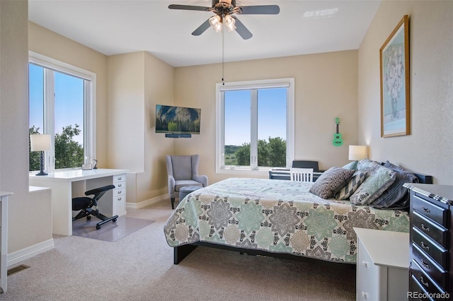 bedroom featuring ceiling fan and light colored carpet