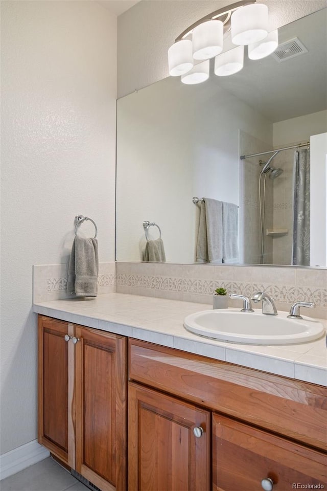 bathroom featuring vanity and curtained shower