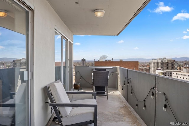 balcony with a mountain view and a view of city