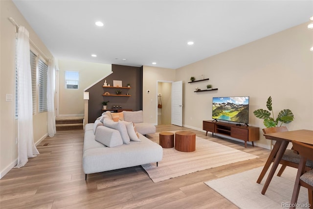 living area with recessed lighting, baseboards, and light wood-type flooring