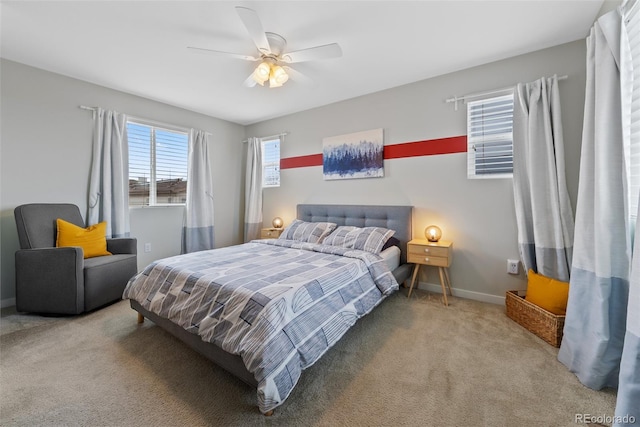 carpeted bedroom with baseboards and ceiling fan