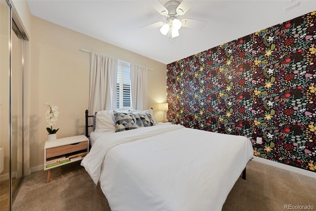 bedroom with carpet floors, baseboards, ceiling fan, and a closet