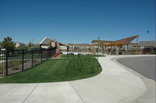 view of home's community featuring fence and a yard