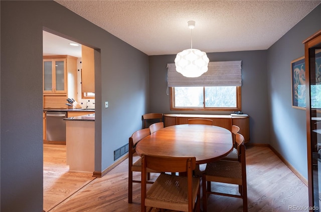17530 E Caspian Pl, Aurora, CO 80013 - dining room with light wood-type flooring and a textured ceiling