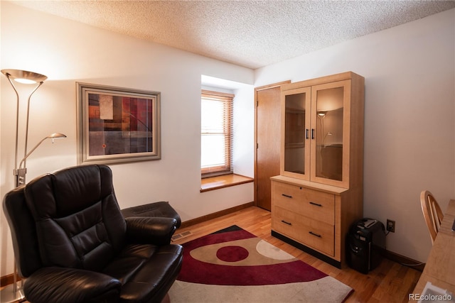 17530 E Caspian Pl, Aurora, CO 80013 - living area with light wood finished floors and a textured ceiling