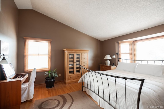 17530 E Caspian Pl, Aurora, CO 80013 - bedroom featuring vaulted ceiling and wood finished floors