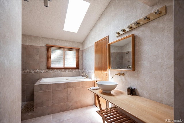 17530 E Caspian Pl, Aurora, CO 80013 - full bathroom with lofted ceiling, a garden tub, vanity, tile patterned floors, and a skylight