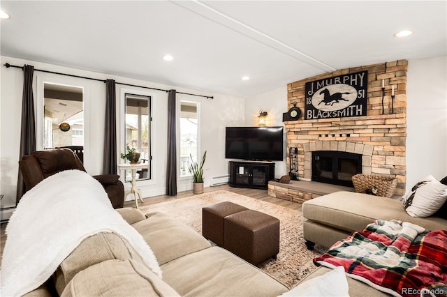 living room with recessed lighting, wood finished floors, and a baseboard radiator