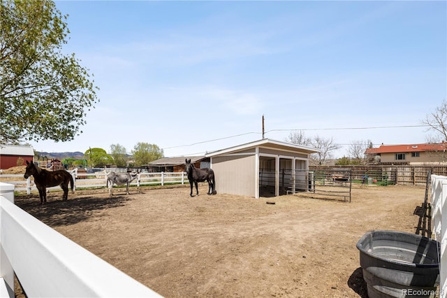 view of yard with an outdoor structure, an exterior structure, and a rural view