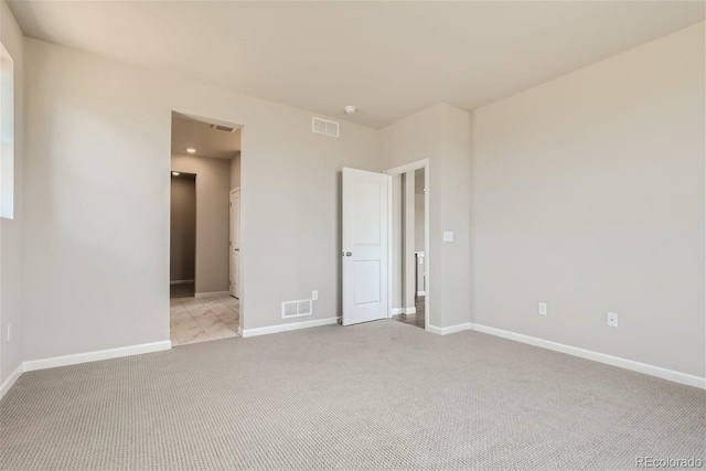 unfurnished bedroom with light colored carpet