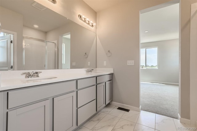 bathroom featuring an enclosed shower and vanity