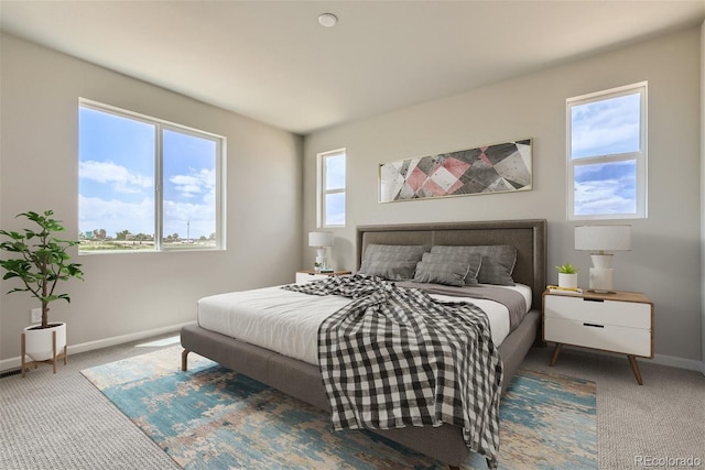 carpeted bedroom featuring multiple windows