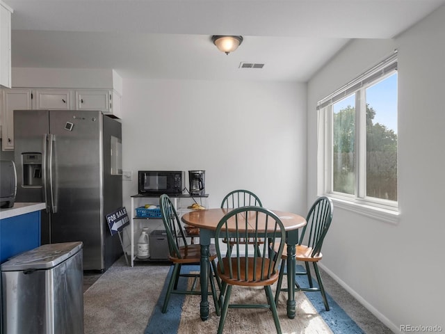 dining space with dark carpet