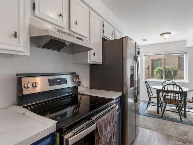 kitchen with white cabinetry, stainless steel electric range oven, and light hardwood / wood-style floors