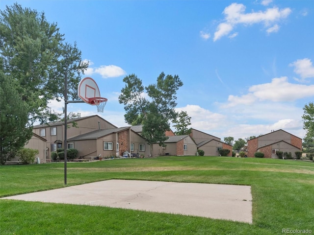 view of basketball court with a lawn