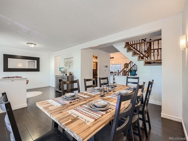 dining space with a textured ceiling and dark wood-type flooring